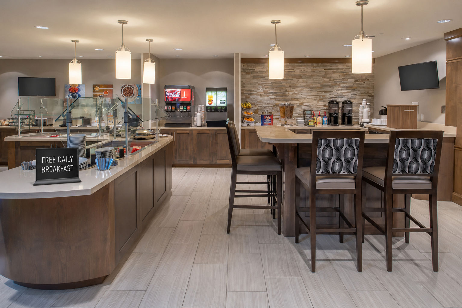 image Breakfast dining area with food stations and seating.