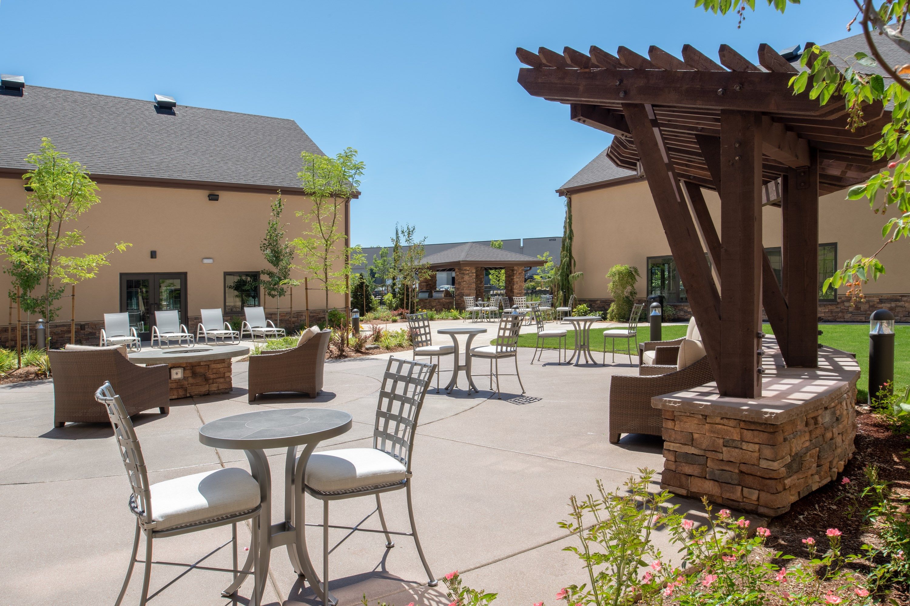 image Outdoor courtyard with seating and landscaped greenery.
