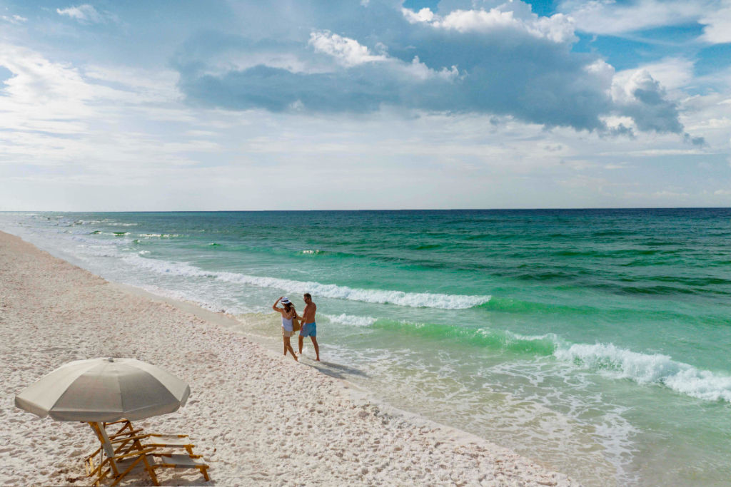 image Indulge in the calm and solitude under a beach umbrella, with the soothing sounds of the sea.