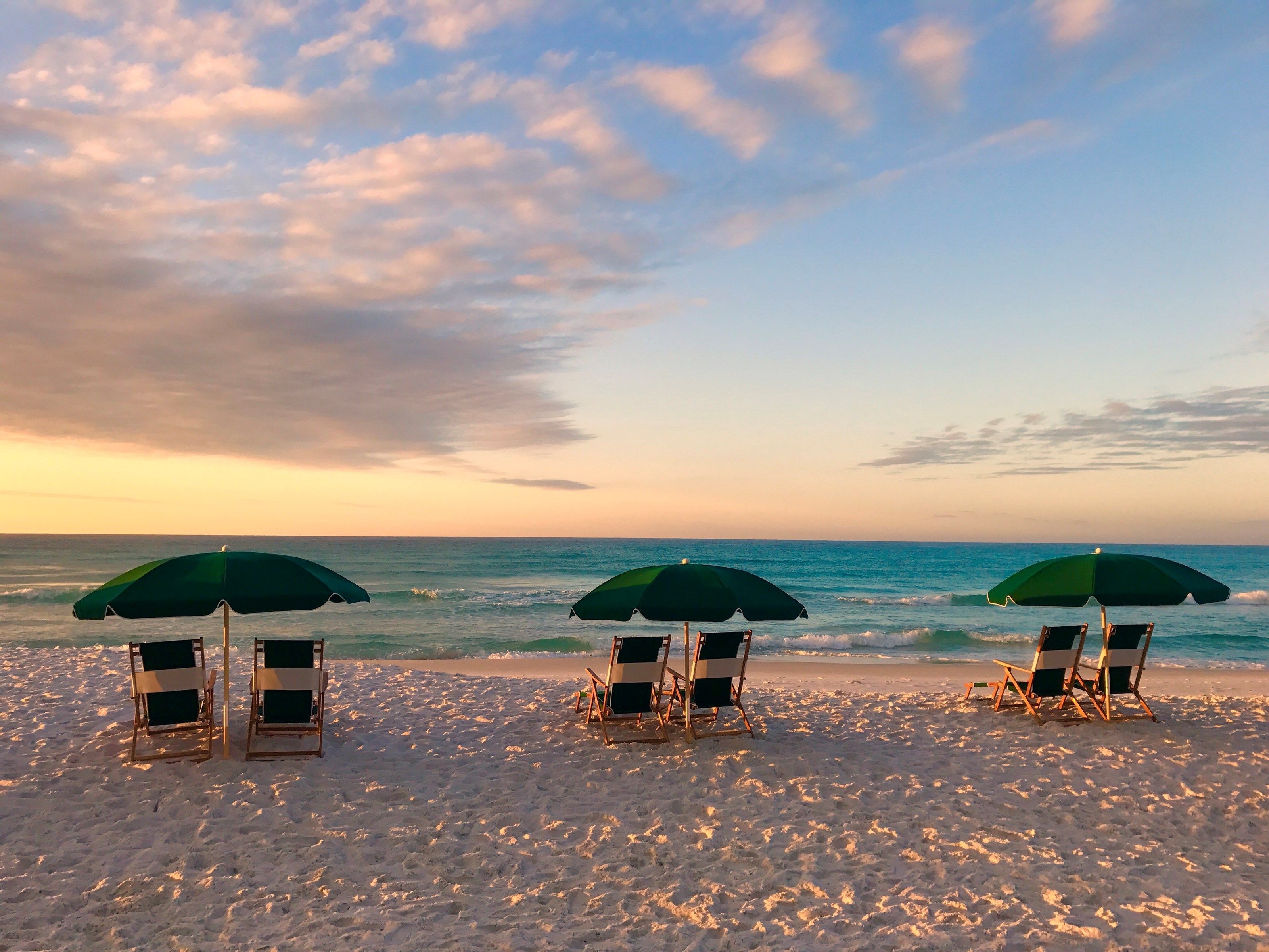 image Go Beachfront view at dusk, offering a picturesque end to the day with waterfront seating.or a swim.