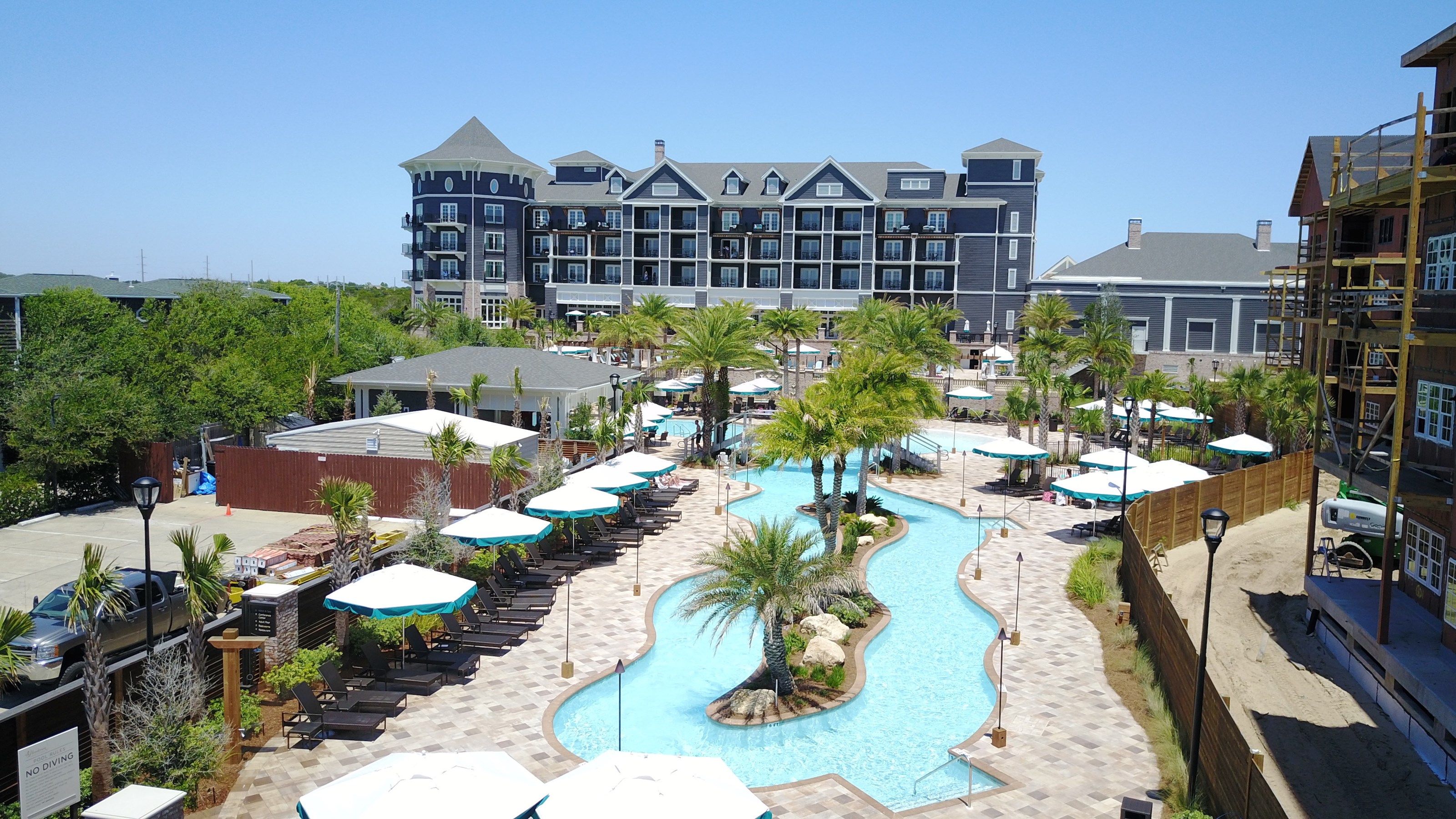 image Resort complex featuring a central pool, ideal for guests seeking both activity and relaxation.