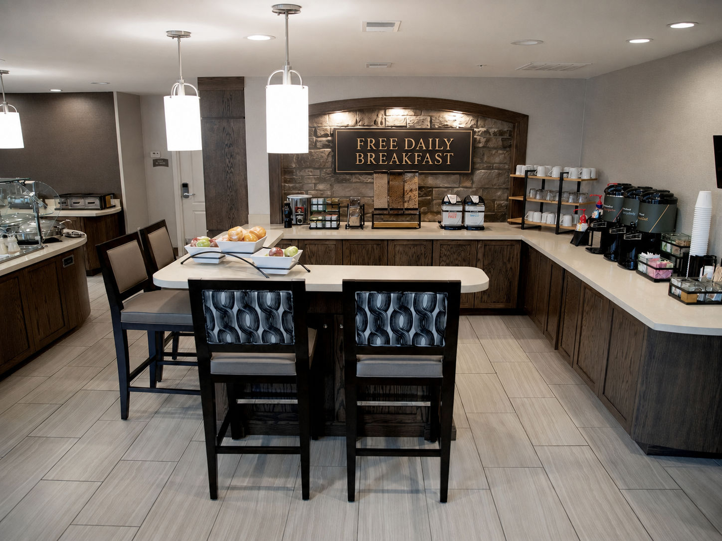 image Breakfast bar with food display, beverage station, and free daily breakfast signage