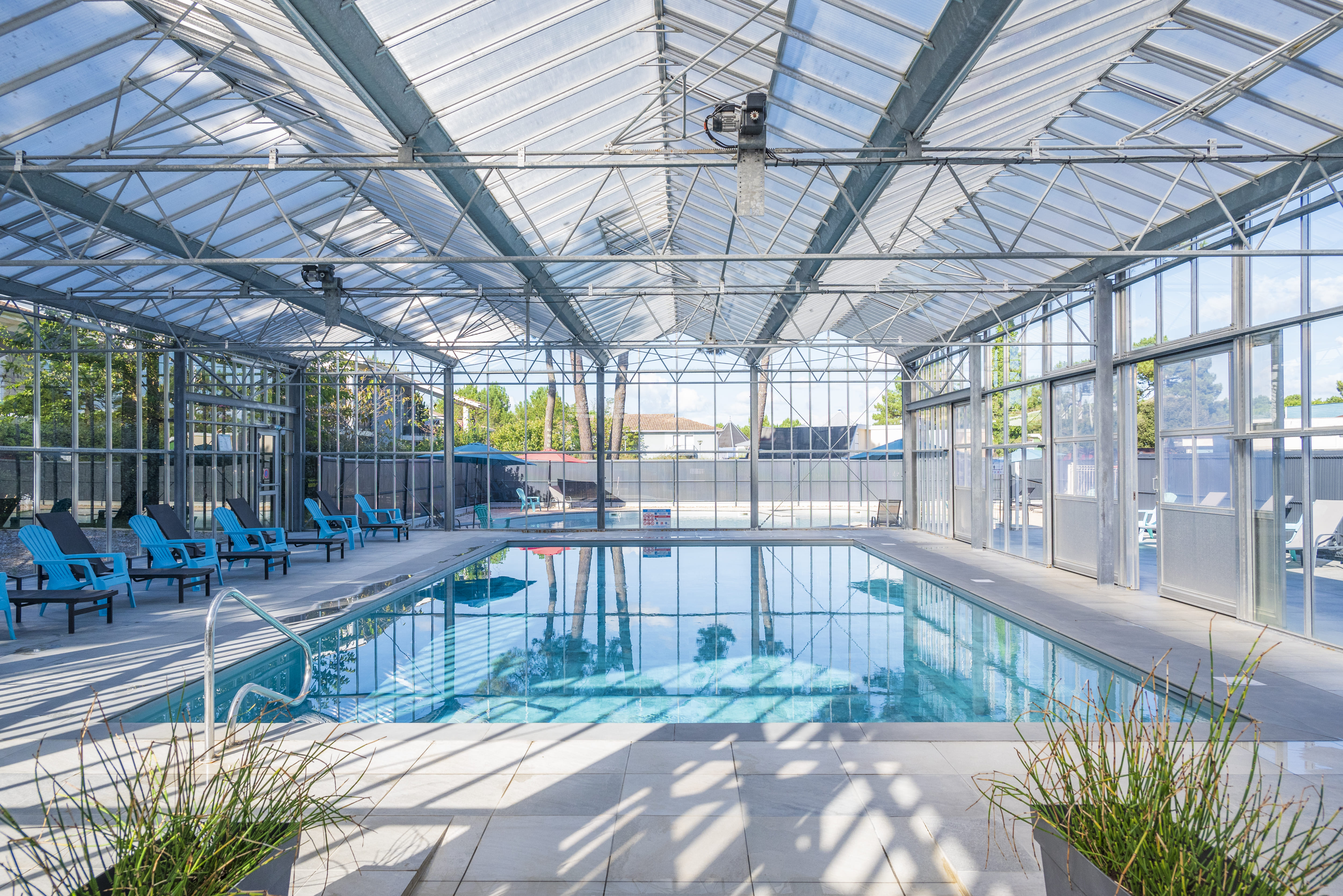 image Blue loungers face floor-to-ceiling windows around the heated indoor pool."