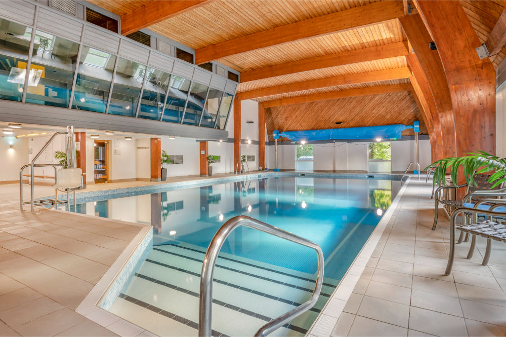 image Enclosed pool with a clear roof, offering year-round enjoyment regardless of weather.