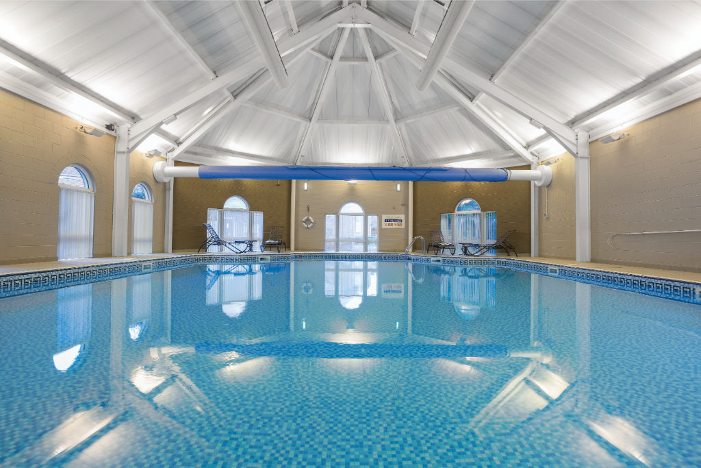 image An indoor pool under a vaulted ceiling, offering a serene spot for a swim in any weather.