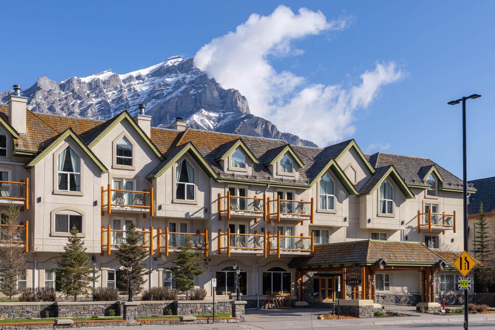 image Three-story building on Banff Avenue with timber balconies and Cascade Mountain rising behind