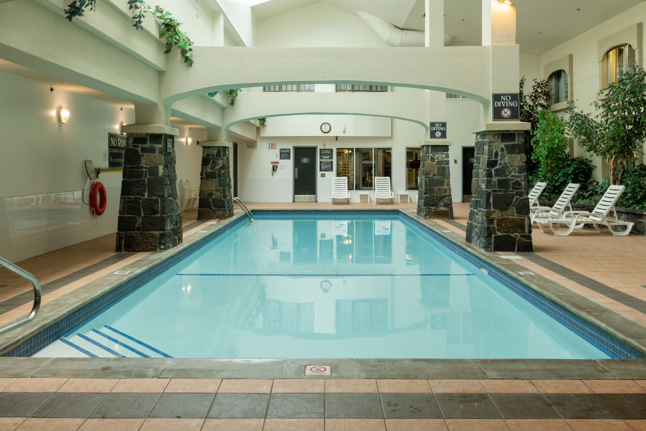 image Full-length view of the indoor pool with lounge seating on both sides