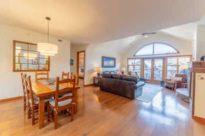 Dining area with a wooden table and living room in background