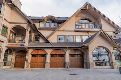 Multi-story building with wooden doors and balconies