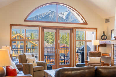 Large windows with mountain and forest views in a living space