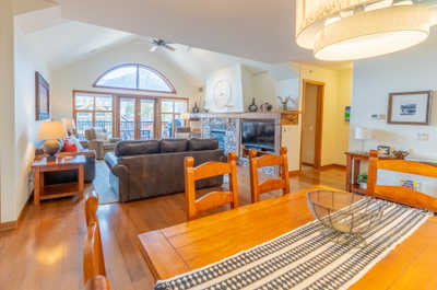 Open living space with large windows, seating area, and fireplace