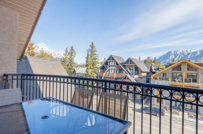 Balcony view of houses and mountains against a blue sky