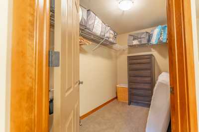 Walk-in closet with built-in shelving and ample storage space for extended stays.