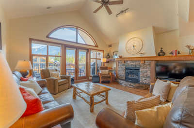 Living room with a fireplace and large windows