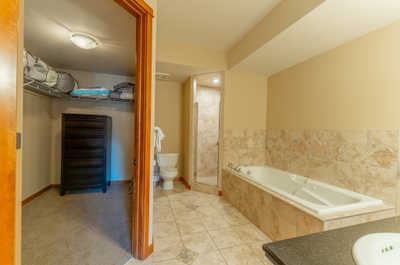 Bathroom with a bathtub, toilet, and storage space