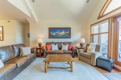 Living room with leather seating and a colorful painting