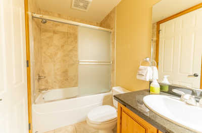 The second bathroom has a shower-tub combo and sink vanity