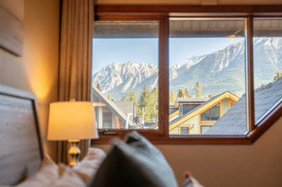 Mountain view from inside a room through a large window