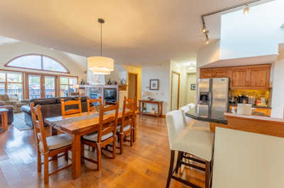 Dining table and kitchen with large windows