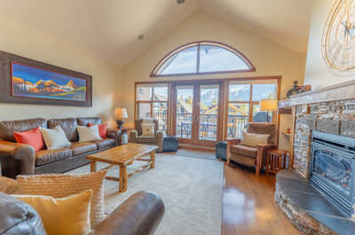 Spacious lounge with sofa, coffee table, and artwork on the wall