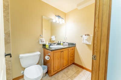 Another angle of the second bathroom showing the vanity, mirror, and toiletry essentials