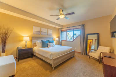 Bedroom with a bed, chair, and large mirror