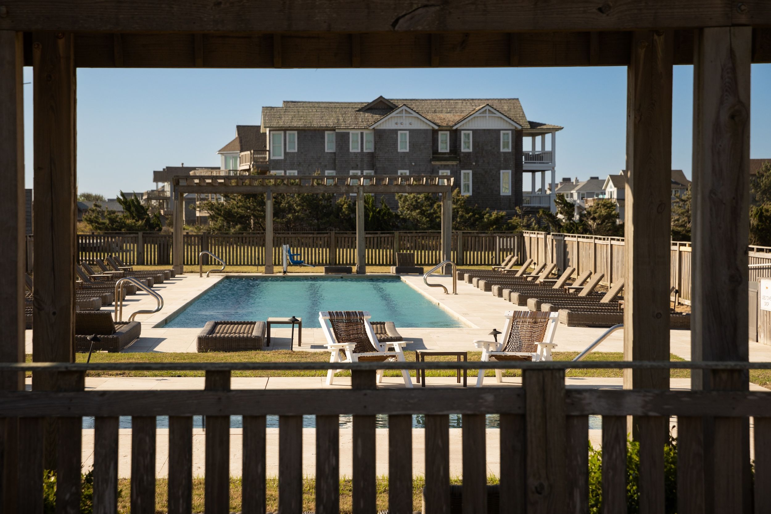 image Unwind by the outdoor pool, surrounded by sun loungers and the open skies of Duck, NC