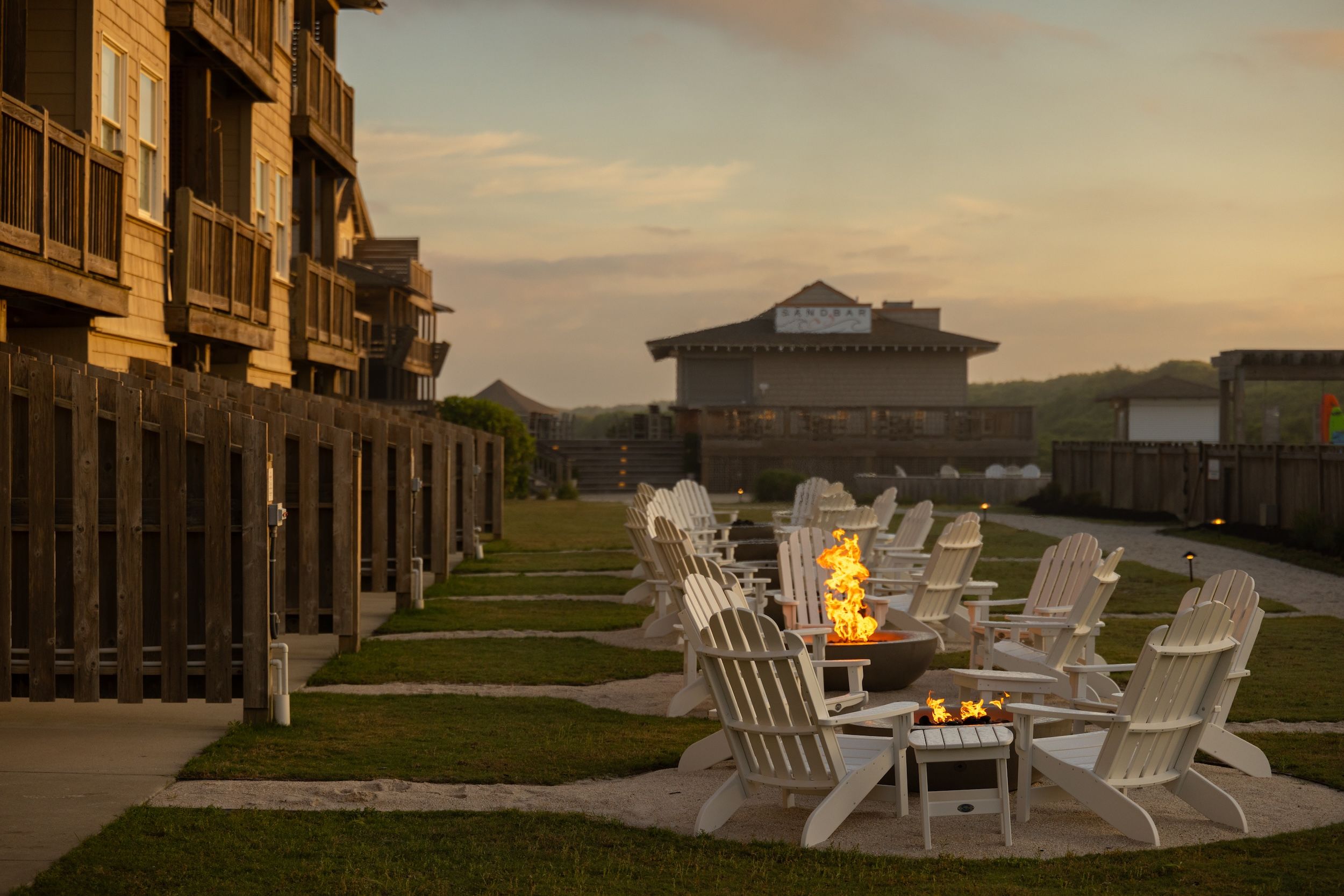 image Gather around the fire pits as twilight falls, sharing stories under the open sky