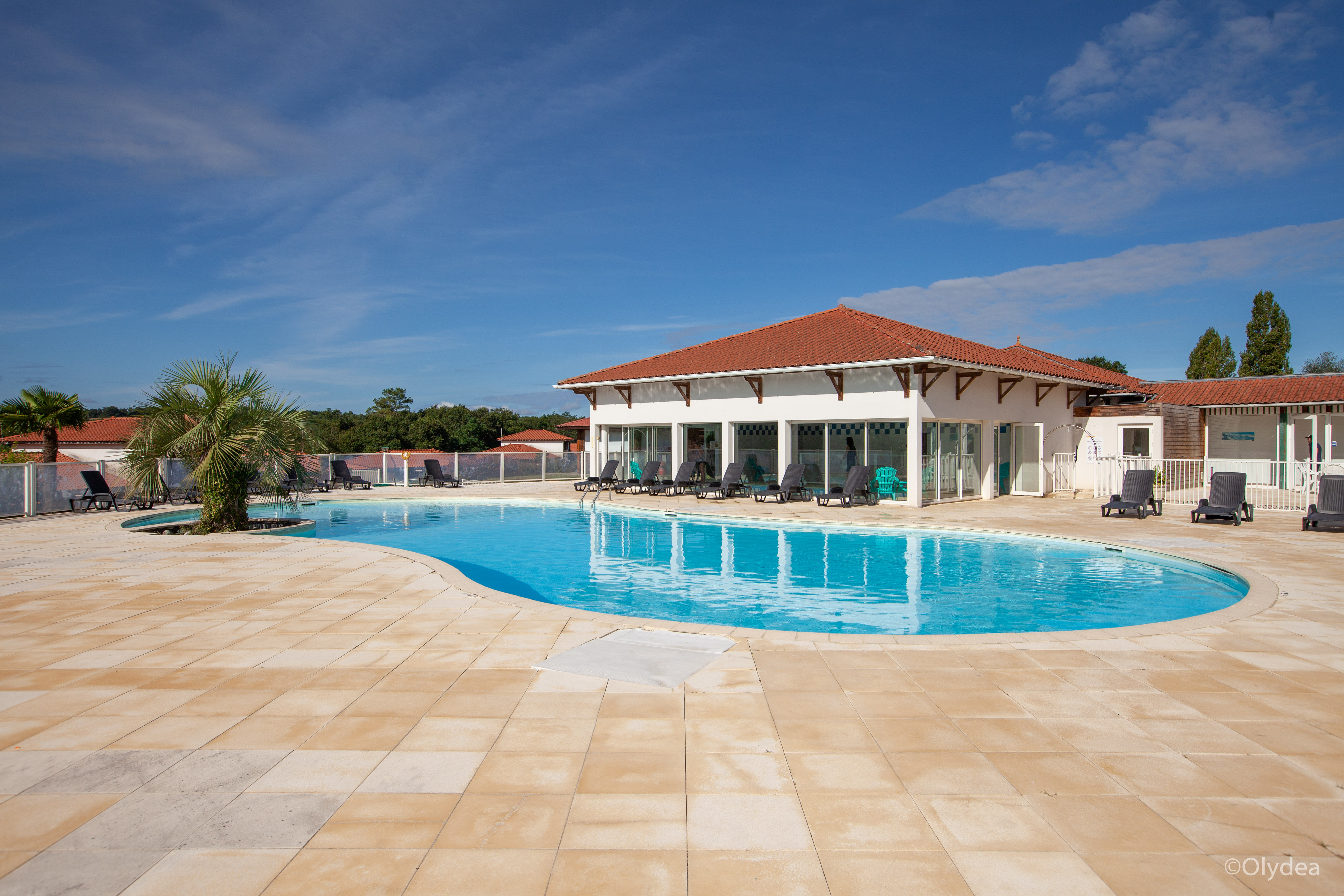 image Lounge by the pool in the sunshine and take a dip in the outdoor pool.