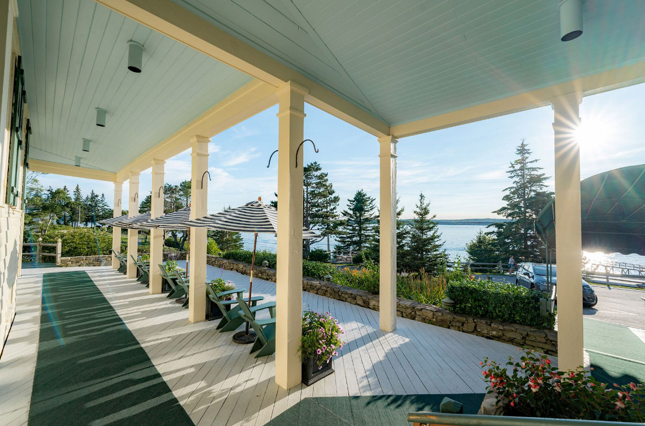 image Begin the day with still waters and golden light as you lounge beneath the quiet charm of a wraparound porch.