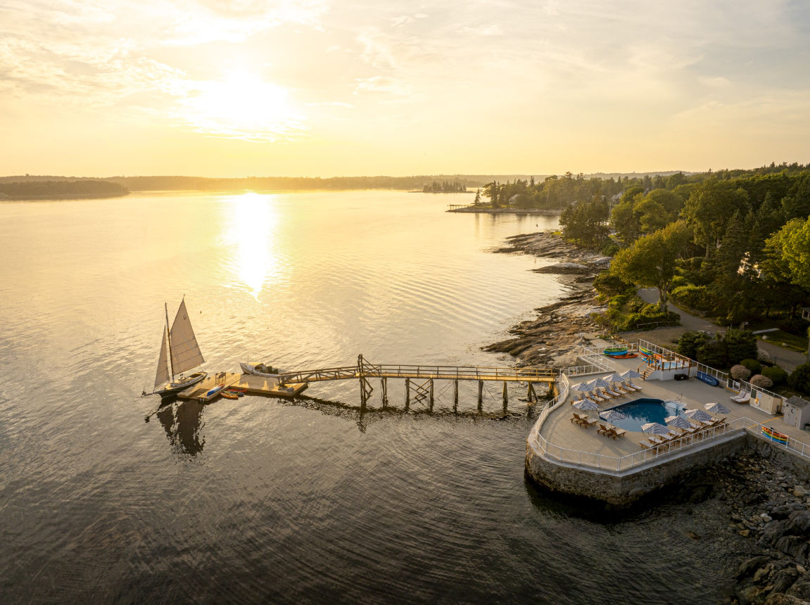image Watch the sun sink over sparkling waters where peaceful docks and gentle waves set the pace.