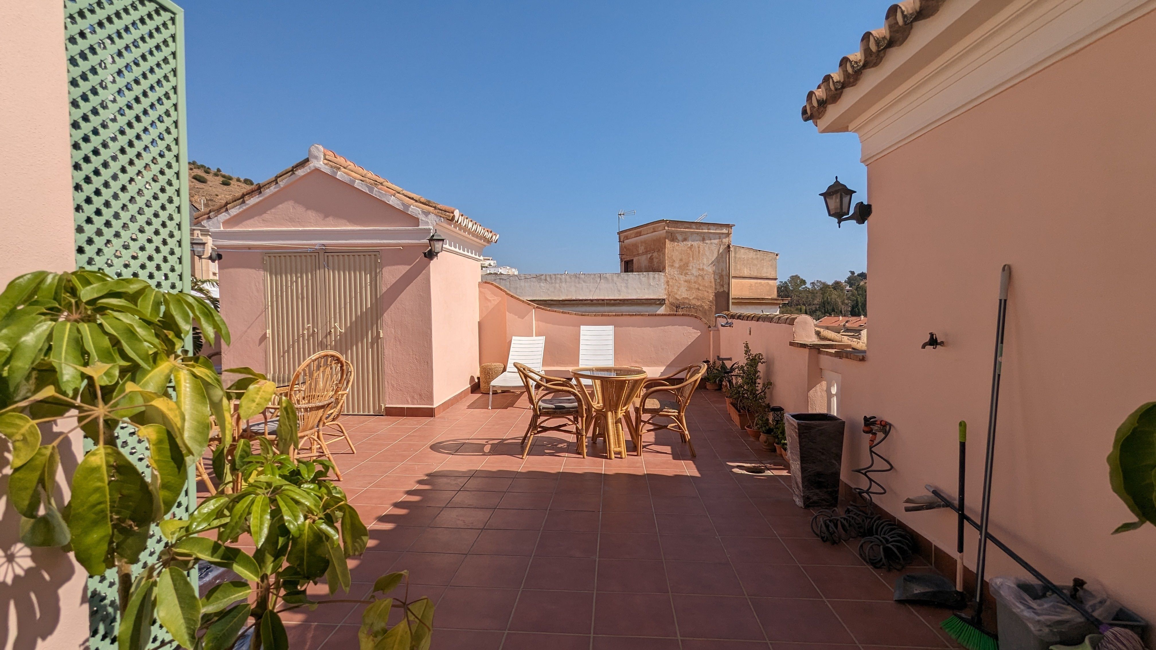 image A wide terrace with dining and lounge seating for soaking up the sun.