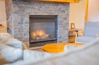 Relax by the warm glow of the fireplace, a perfect spot to unwind after a day of adventure.