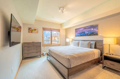 Wake up to the gentle glow of natural light in a stylish bedroom complete with mountain-inspired decor.