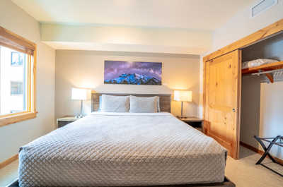 Unwind in this inviting space, with comfortable bedding and warm wood accents enhancing your restful getaway.