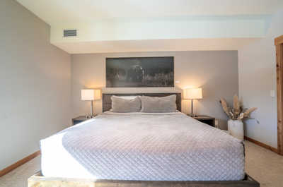 Wake up to cozy mornings in this inviting bedroom, complete with soft linens and serene decor.