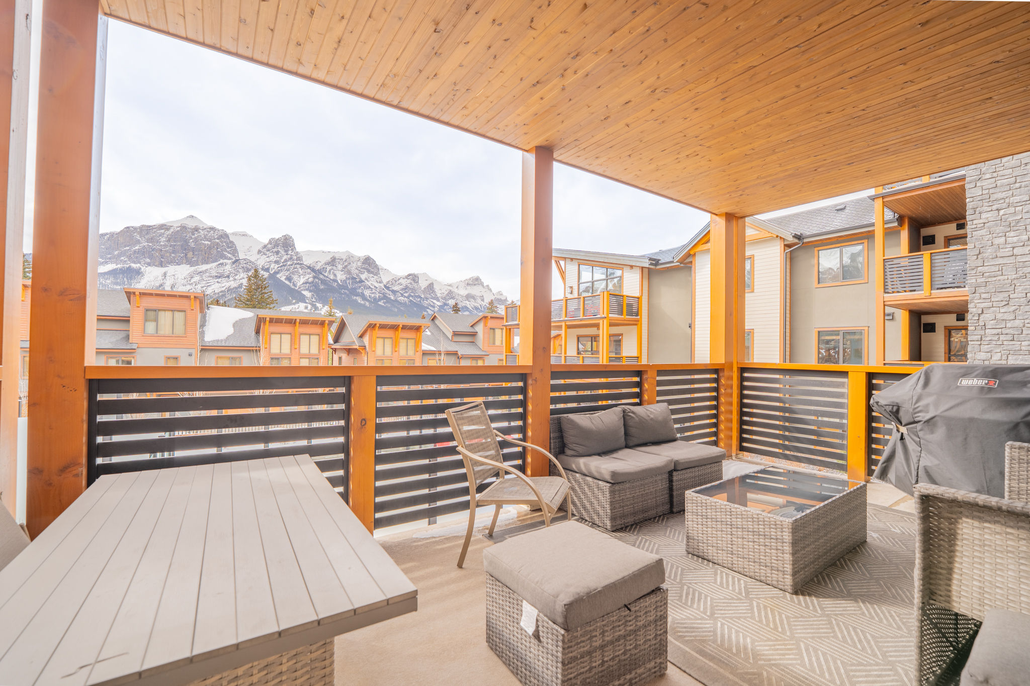 image Savor mountain views and fresh air from your private covered balcony with relaxing seating.