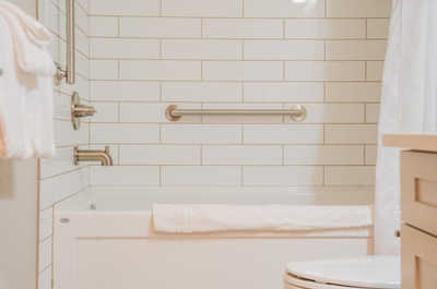 Unwind in this soothing bathroom space featuring a clean tub, perfect for a comforting soak.