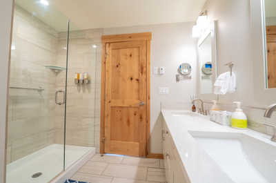 Indulge in this chic bathroom with a spacious shower and contemporary design for your self-care rituals.