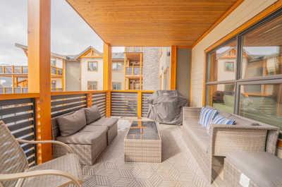 Enjoy the comforts of your covered balcony, complete with cozy seating and a BBQ grill for delightful meals.