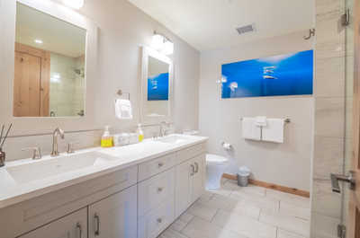 Step into a relaxing retreat with modern finishes and warm lighting in this spacious bathroom.