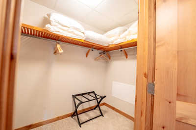 Organize your essentials effortlessly in this well-appointed closet with ample shelving.