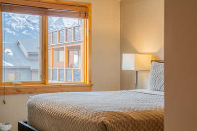 Awake to cozy mornings in your bright bedroom, with comforting hues and natural light.