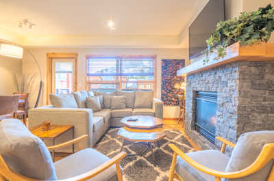 Unwind in a cozy living space, complete with a stylish fireplace and natural light streaming through the windows.