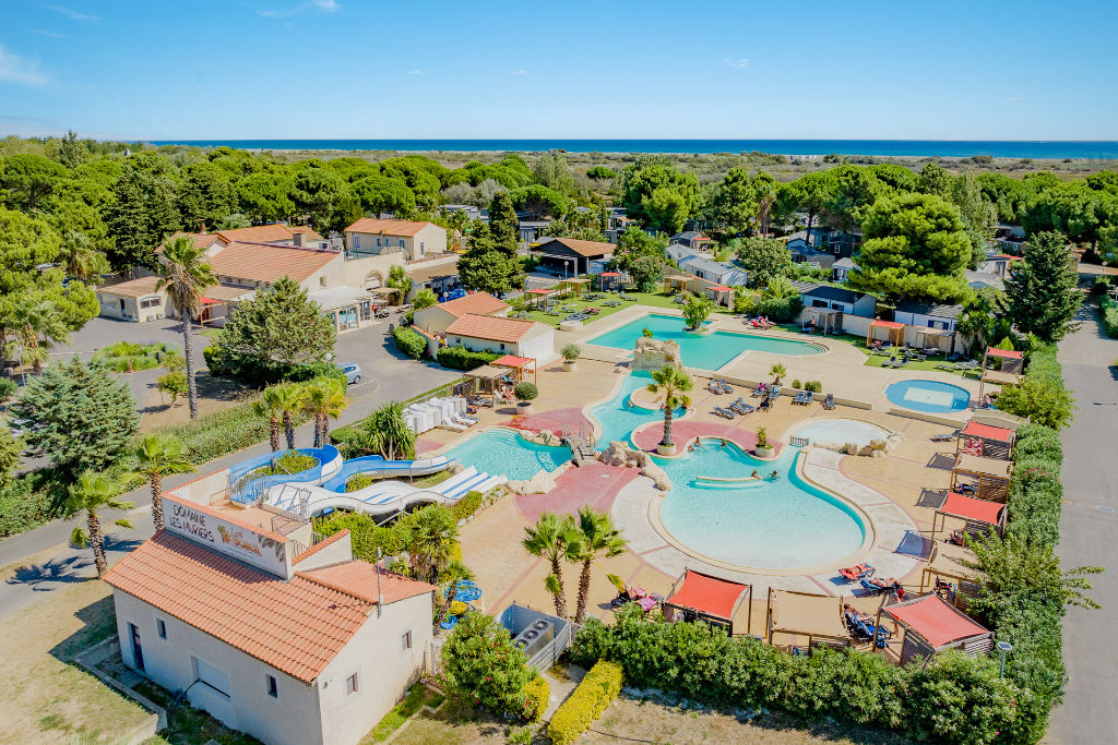 image Overlook the heart of our vibrant resort, a hub of pools and palms under the sun.