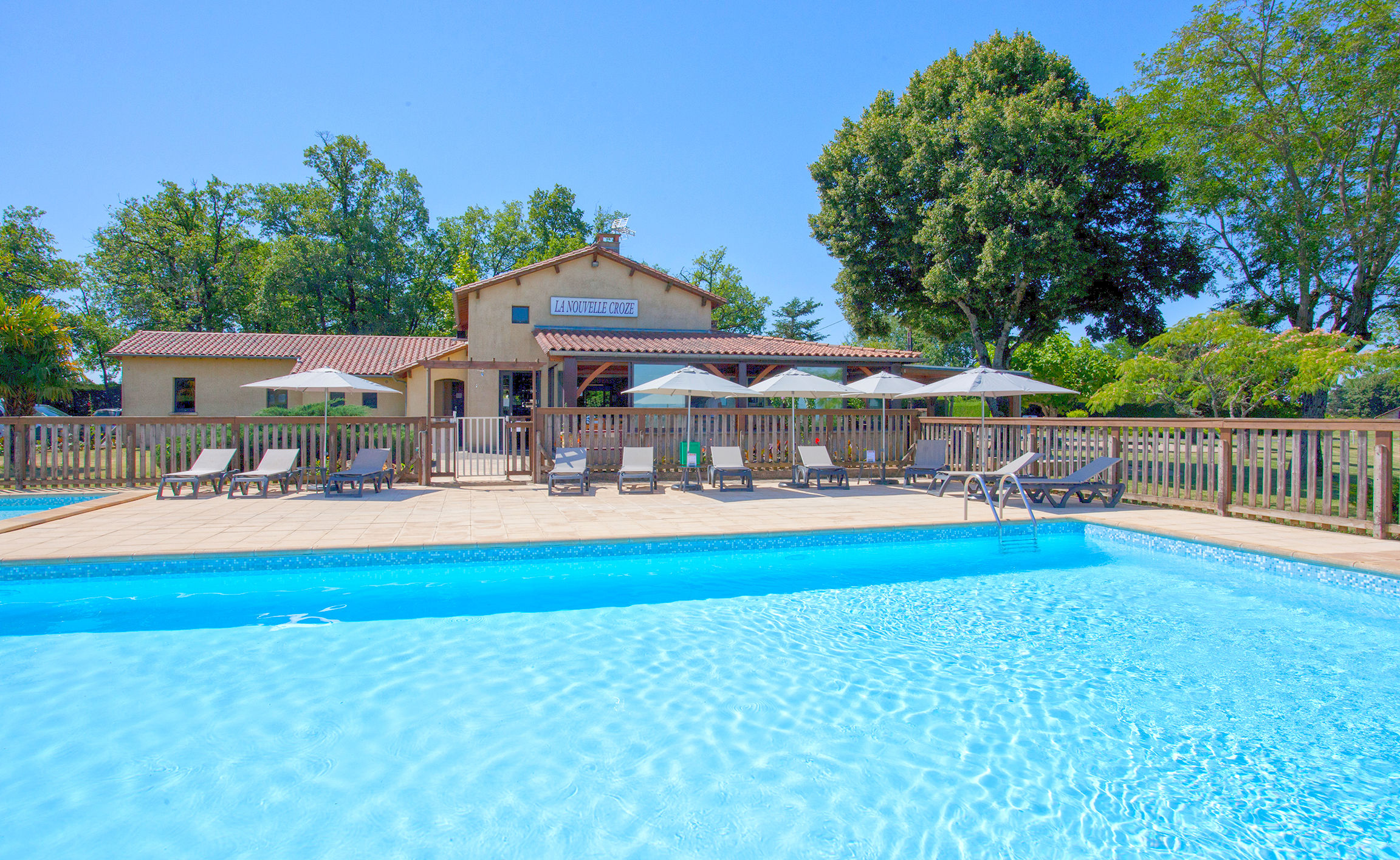 image A serene pool with lush surroundings.