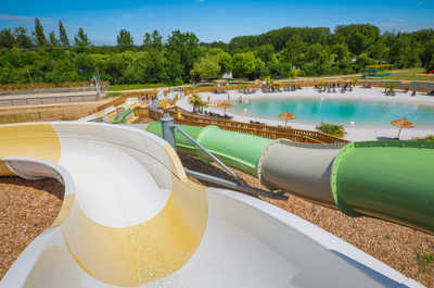 A duo of water slides amidst rolling hills.