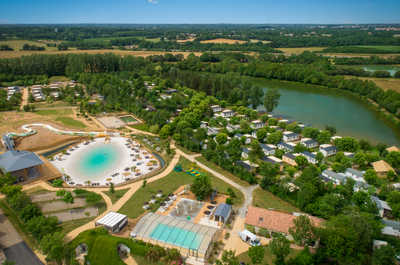 An aerial view of a luxurious pool and lake setting.