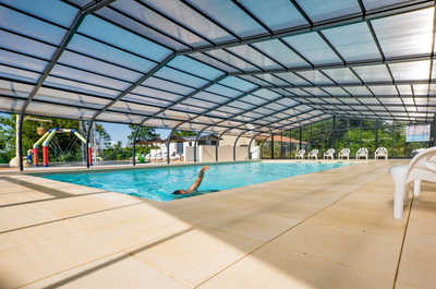 Spacious indoor pool with a glass roof.