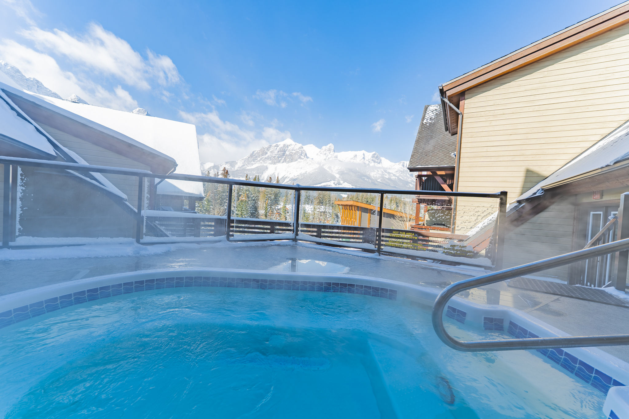 image Hot tub with mountain and building views